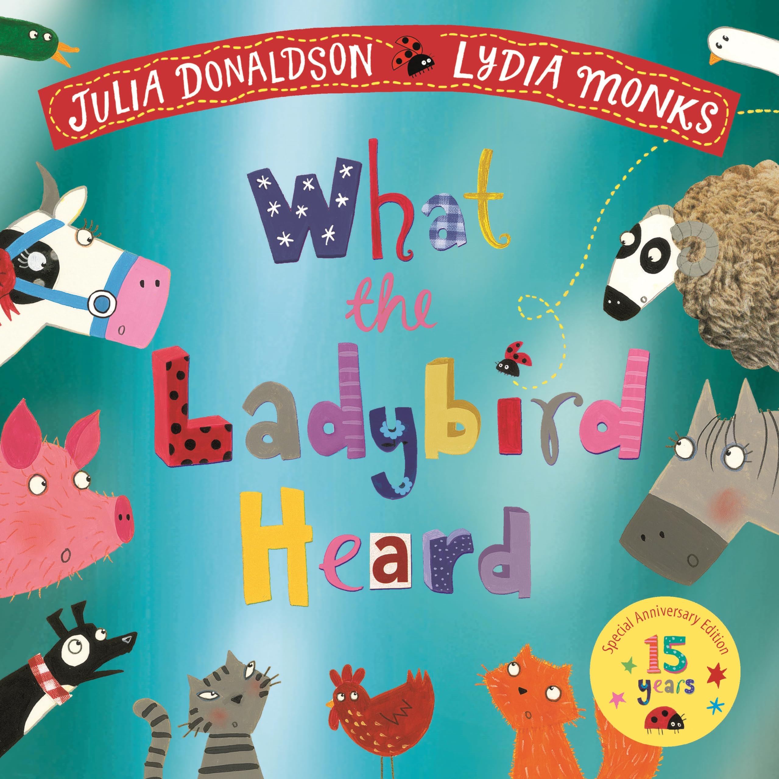 Front cover of the book 'Macmillan Childrens Books What the Ladybird Heard 15th Anniversary Edition with a shiny blue foil cover and bonus materi' by Julia Donaldson.