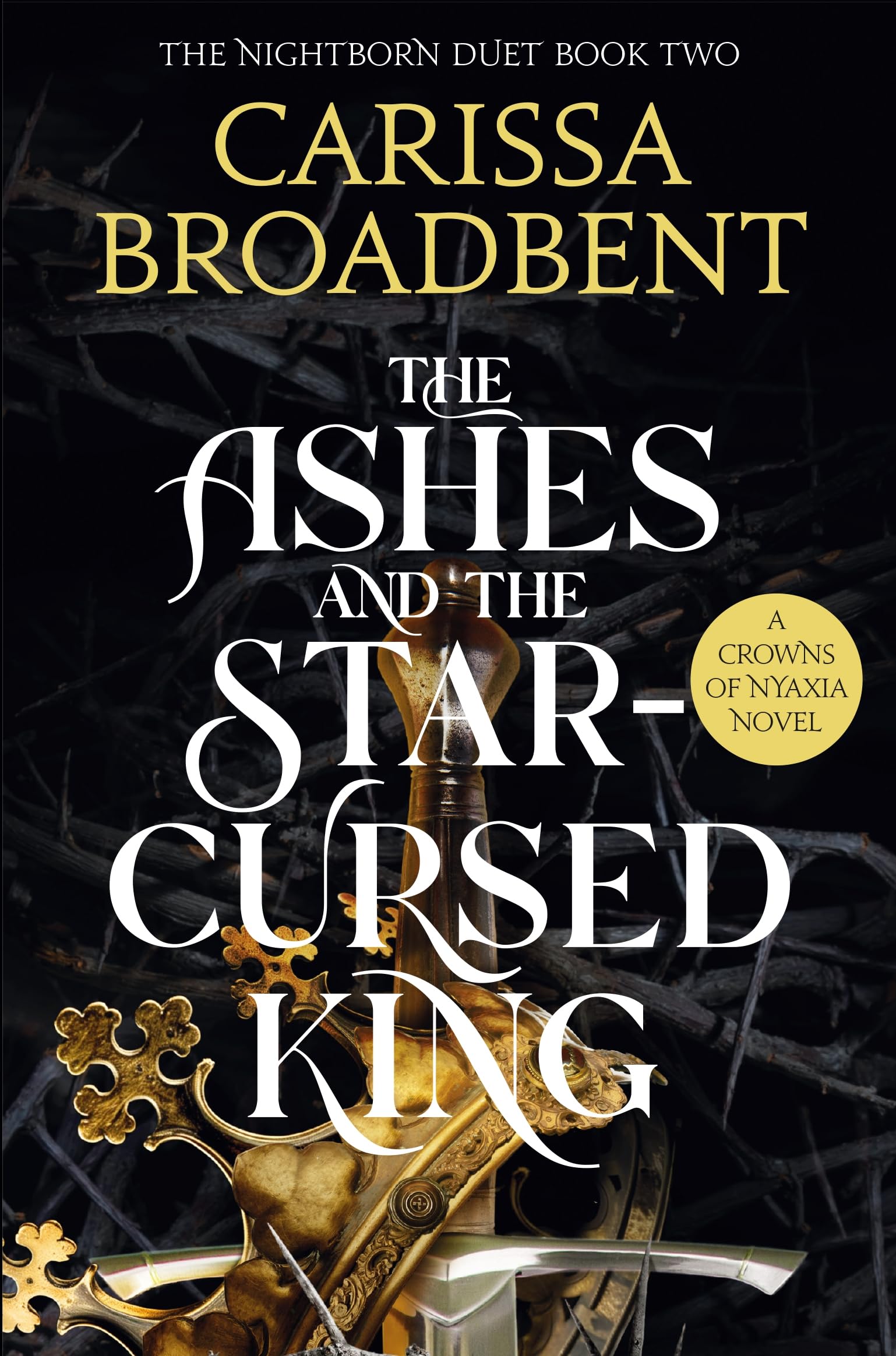 Front cover of the book 'The ashes and the star-cursed king (crowns of nyaxia series)' by Carissa Broadbent.