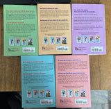 Five paperback books from the brand Dream Books, showing their colorful back covers in shades of blue, green, beige, pink, and purple, arranged on a wooden surface.